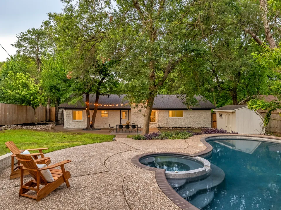 Spa and pool with new coping and two Adirondack chairs