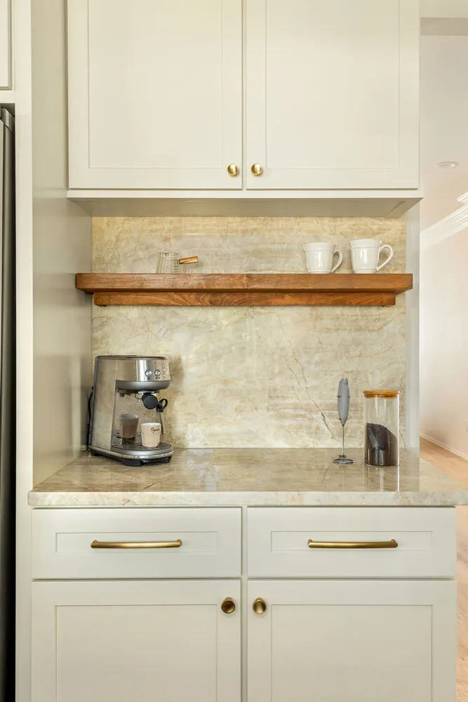 Coffee station with a walnut floating shelf on a quartzite backsplash