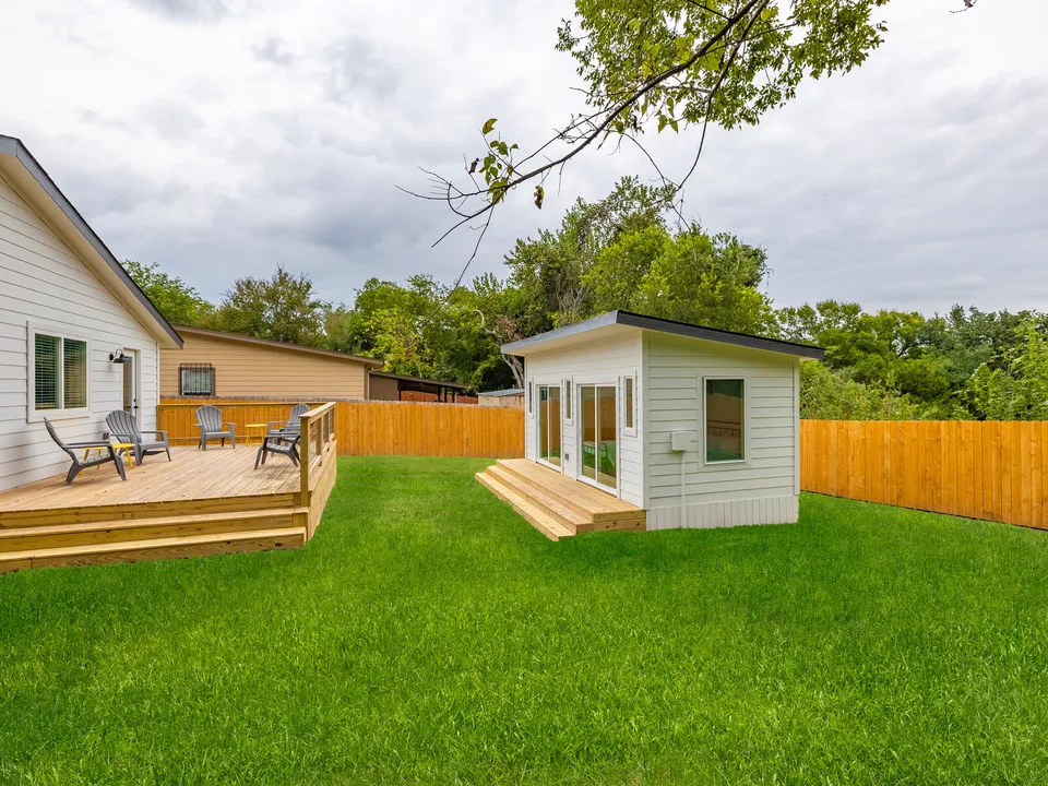 New deck and studio in a fenced backyard