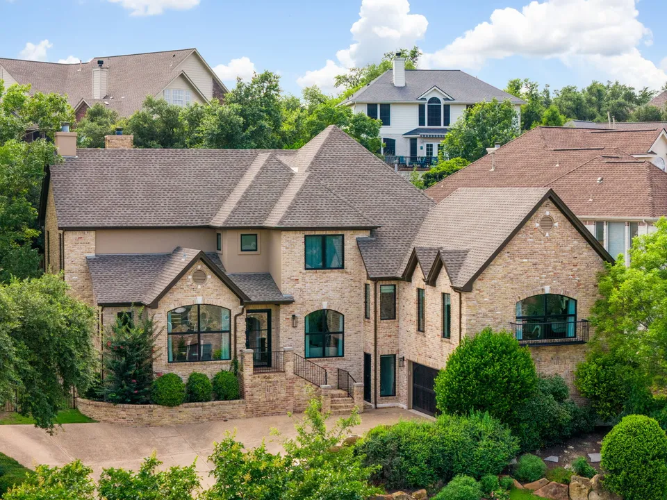 Aerial view of the two-story stone and brick house