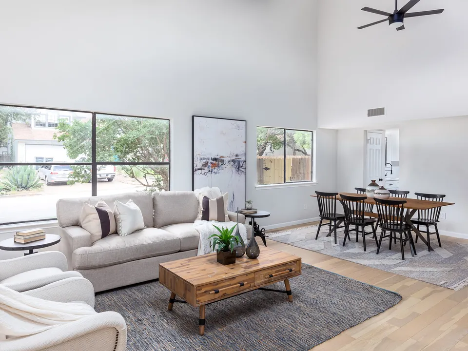 Living room and dining table under a vaulted ceiling
