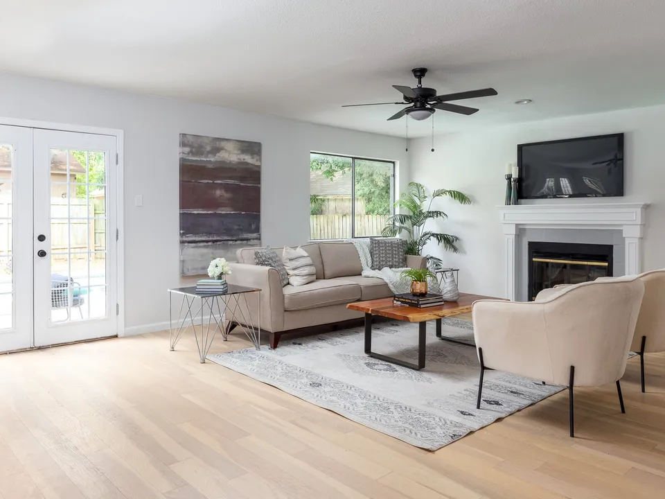 Living room with a fireplace and French doors to the yard