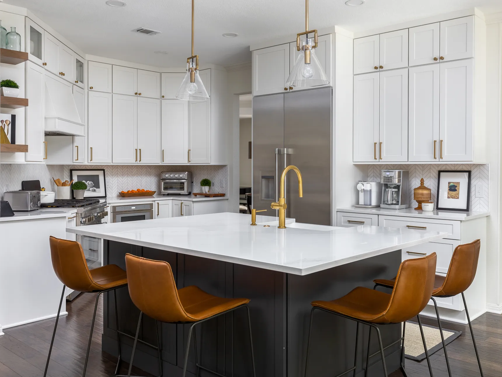 Kitchen remodel with a white quartz island and leather stools