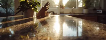 a sleek, polished granite countertop gleaming in a sunlit kitchen.