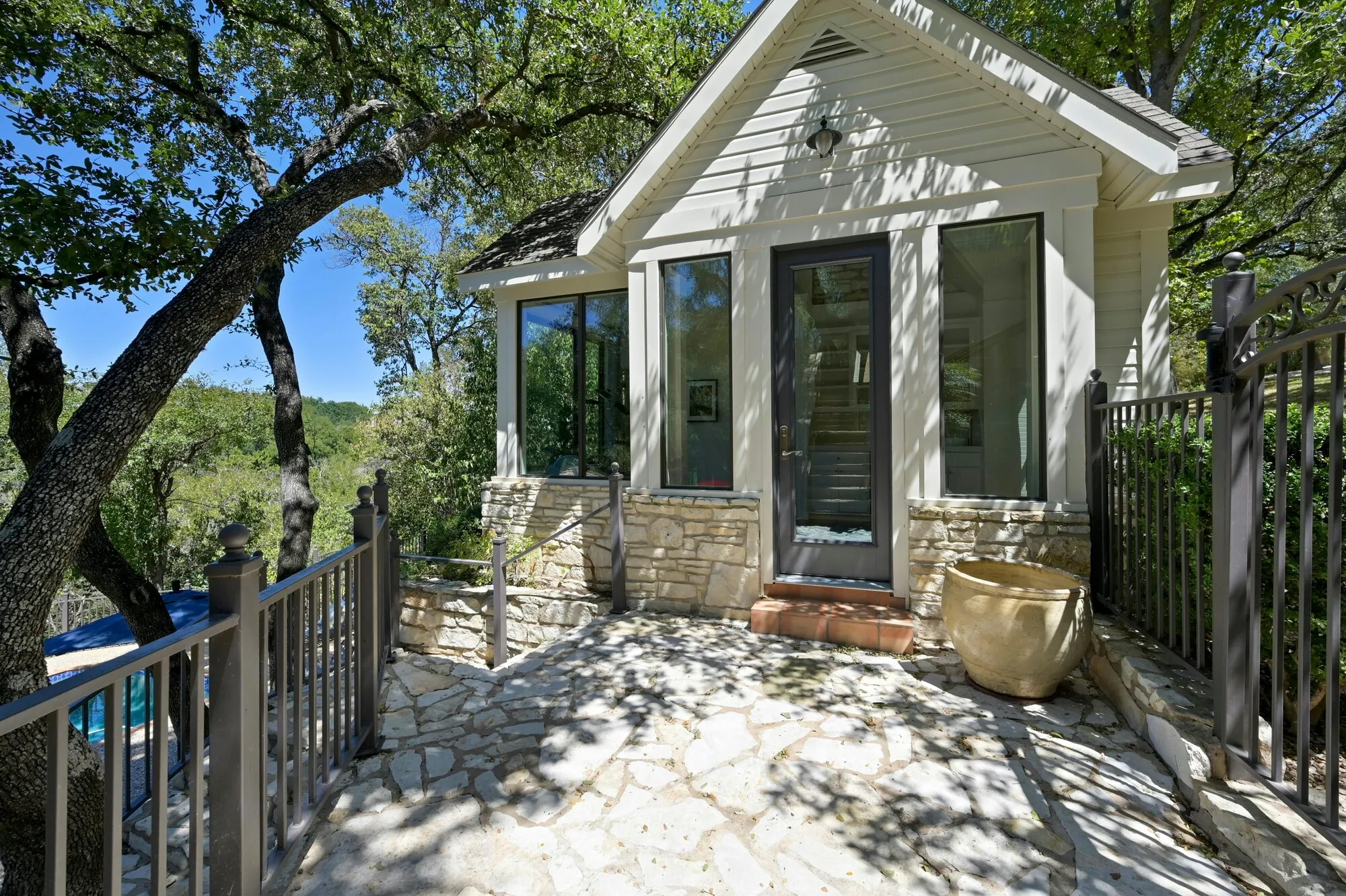 Casita entry with a stone patio under oak trees