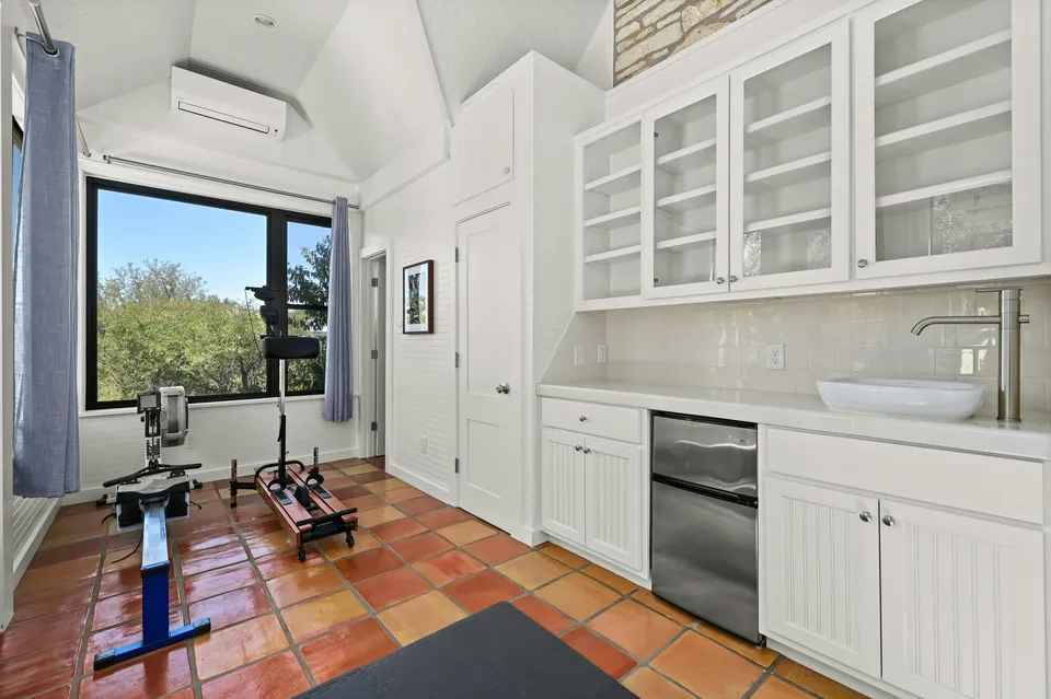 Casita kitchenette with white cabinets and a vessel sink