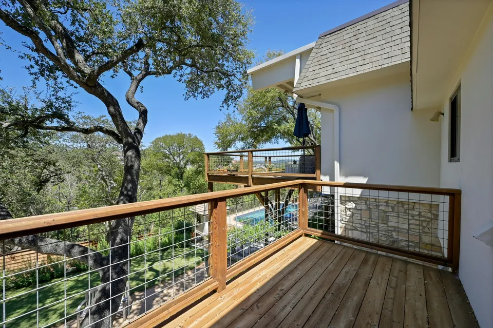 Deck with a cable railing beside the house