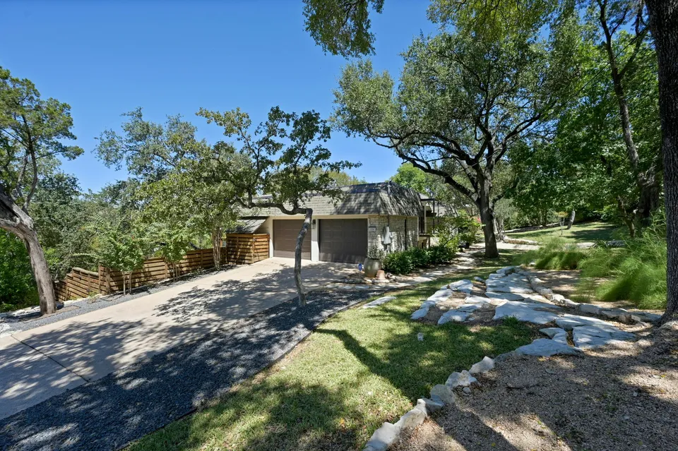 Driveway to the mid-century house under oak trees