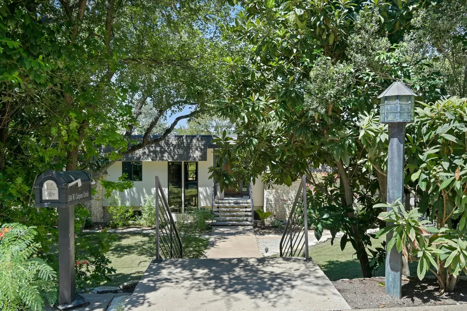 Front walk with a mailbox through a shaded garden