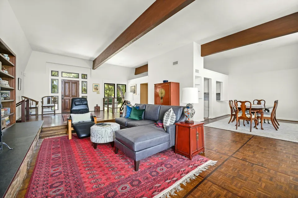 Living room with a grey sectional and a dining area beyond