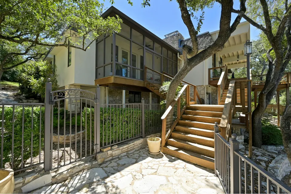 Stairs up to a screened porch and decks