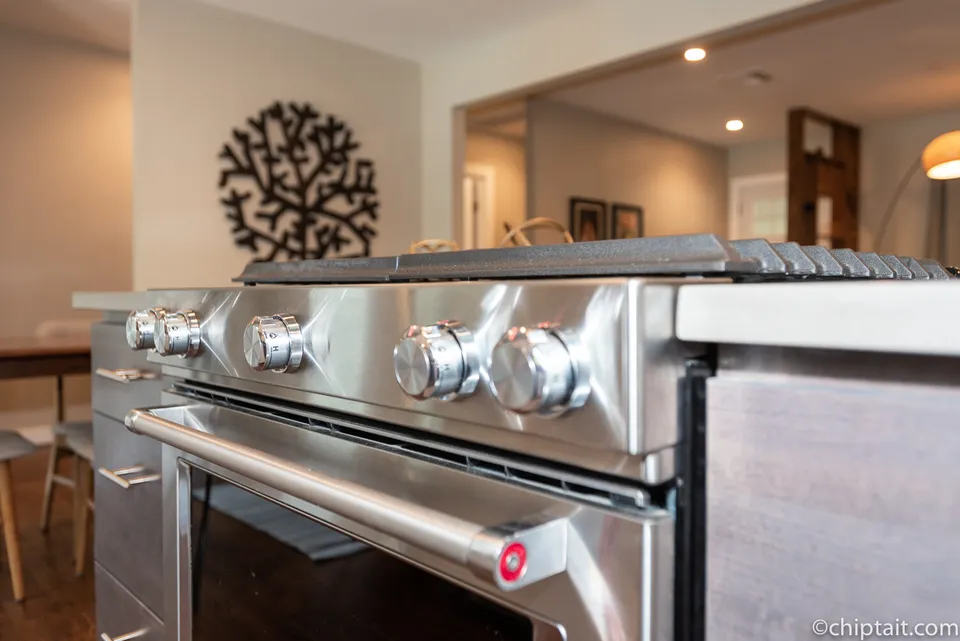Close view of stainless range knobs on the kitchen island