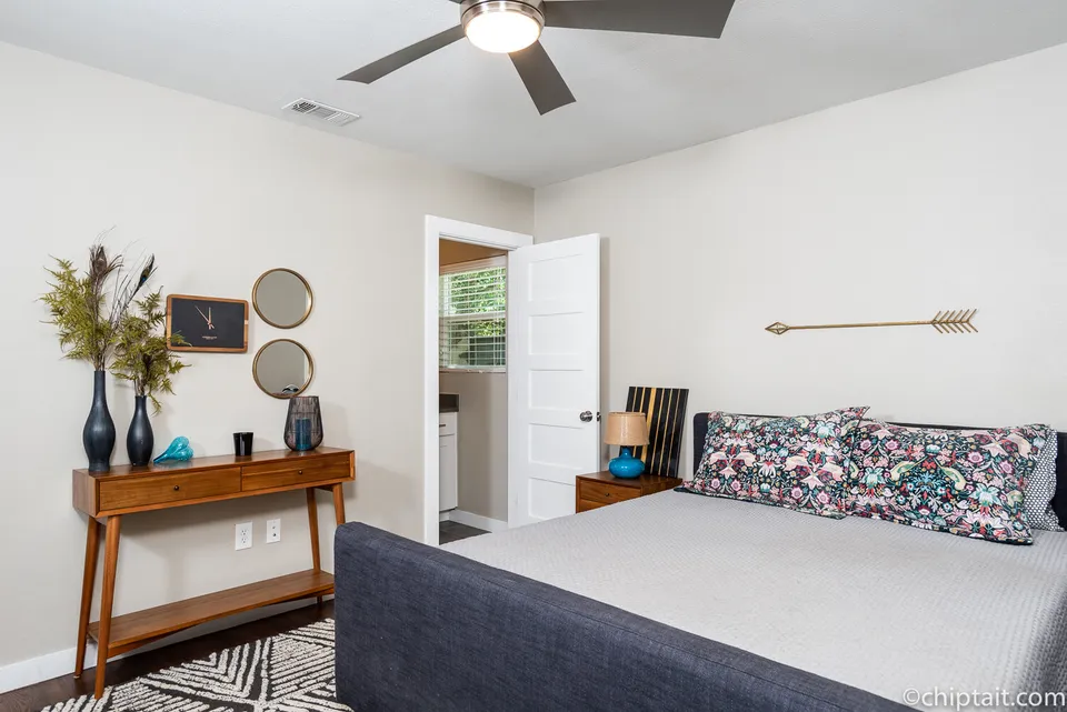 Guest bedroom with a navy upholstered bed and a wood console table