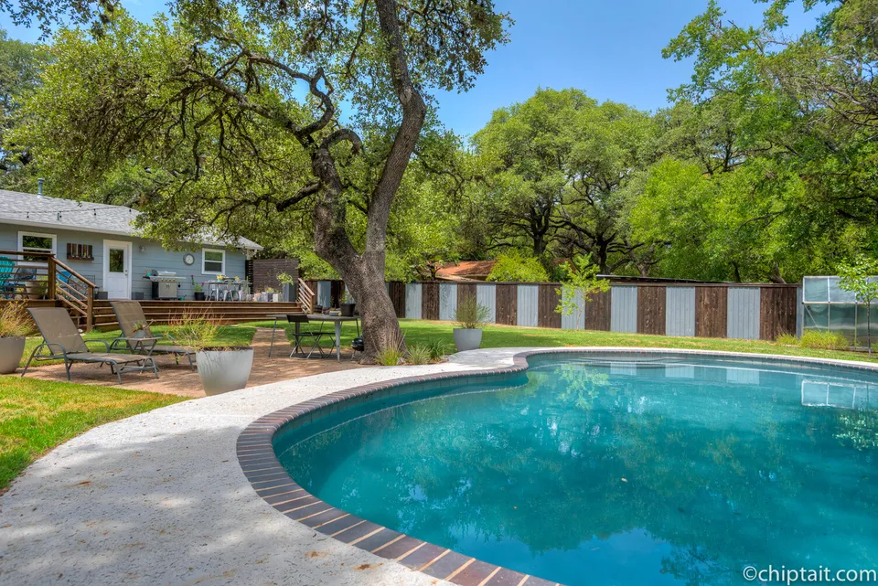 Pool and lawn with the deck and house beyond