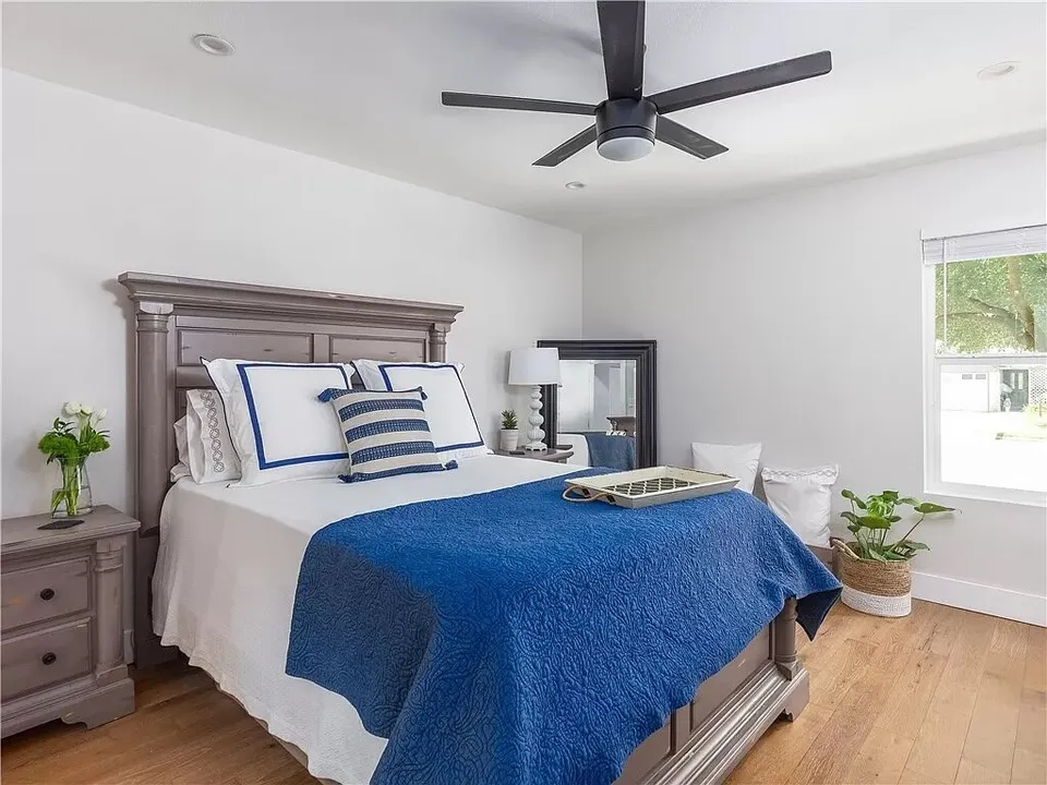 Bedroom with a carved wood headboard and a navy bedspread