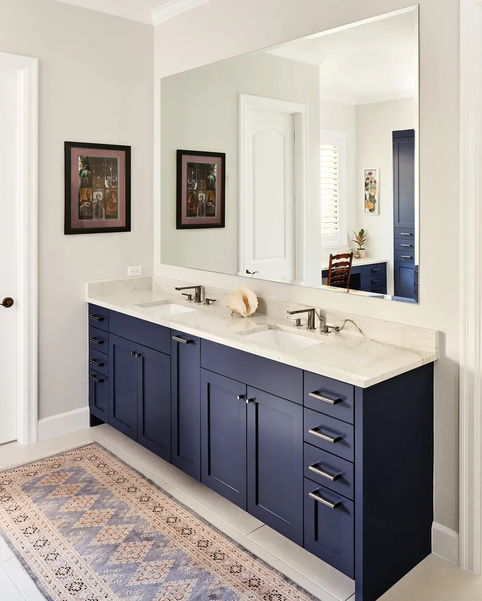 Navy double vanity with a large mirror in the primary bath