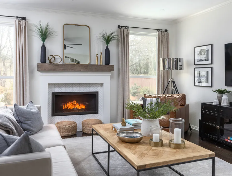 Living room with a white fireplace, a reclaimed wood mantel and a wood coffee table