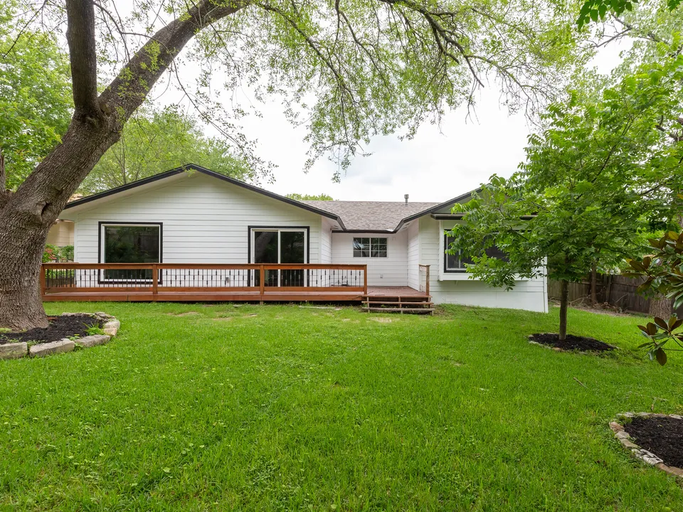 Back of the house with a deck across the full width