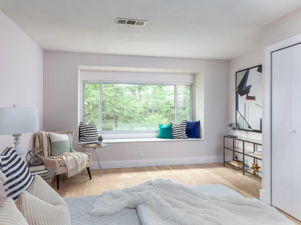Bedroom with a window seat and a sitting chair