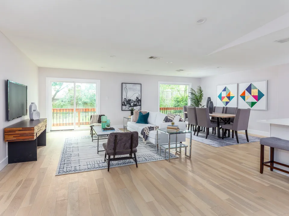 Living and dining area with light oak floors and sliding doors