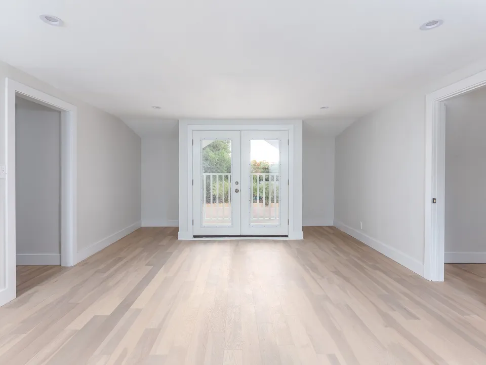 Upstairs room with French doors to a balcony
